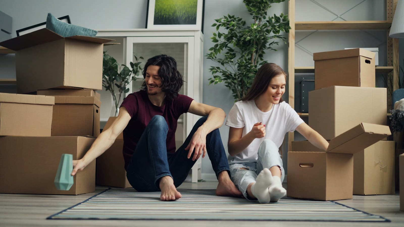 A couple unpacking moving boxes in their new home